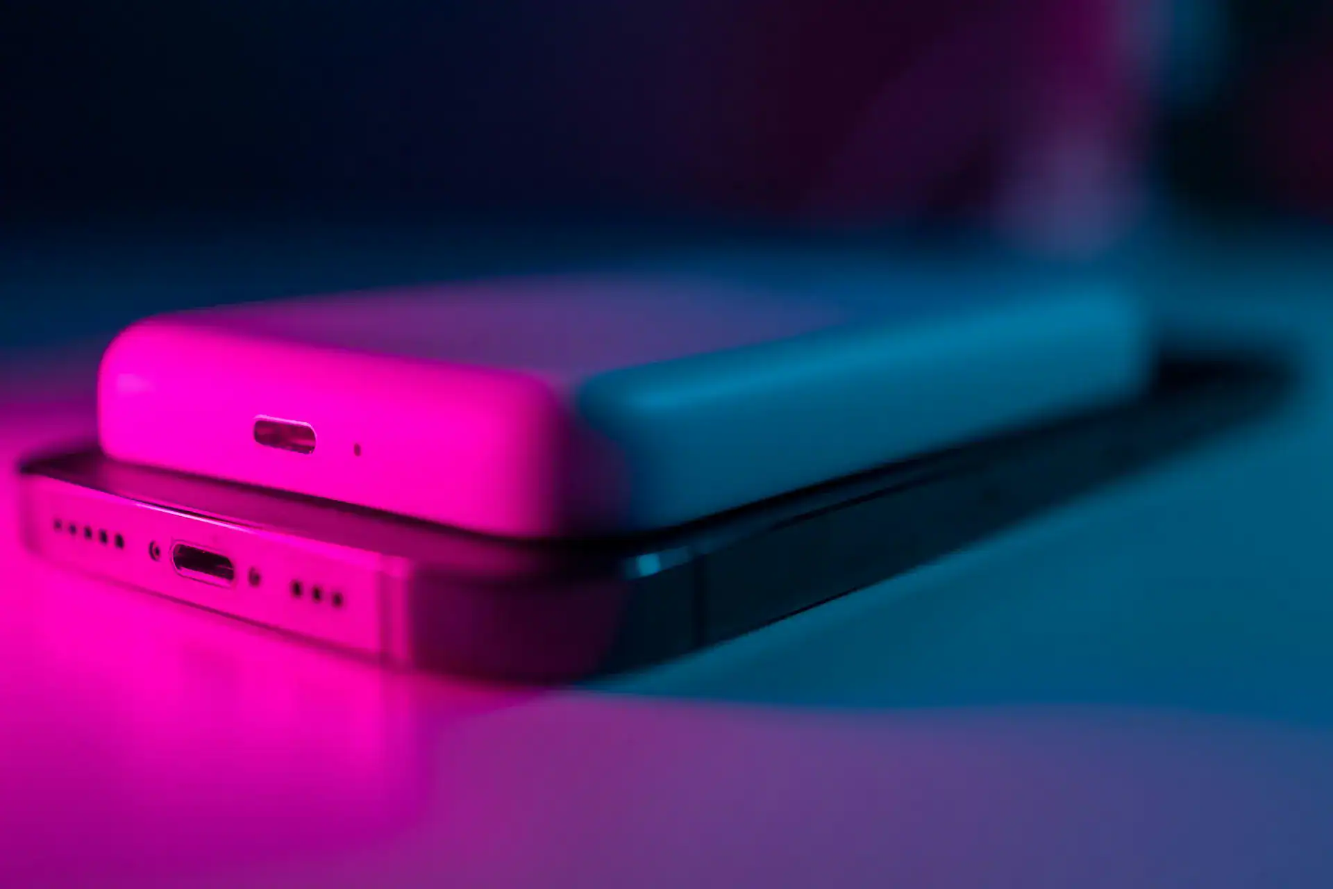 A sleek Anker power bank placed on top of a smartphone, showing compact design and wireless charging capability – ideal for travel or daily use.