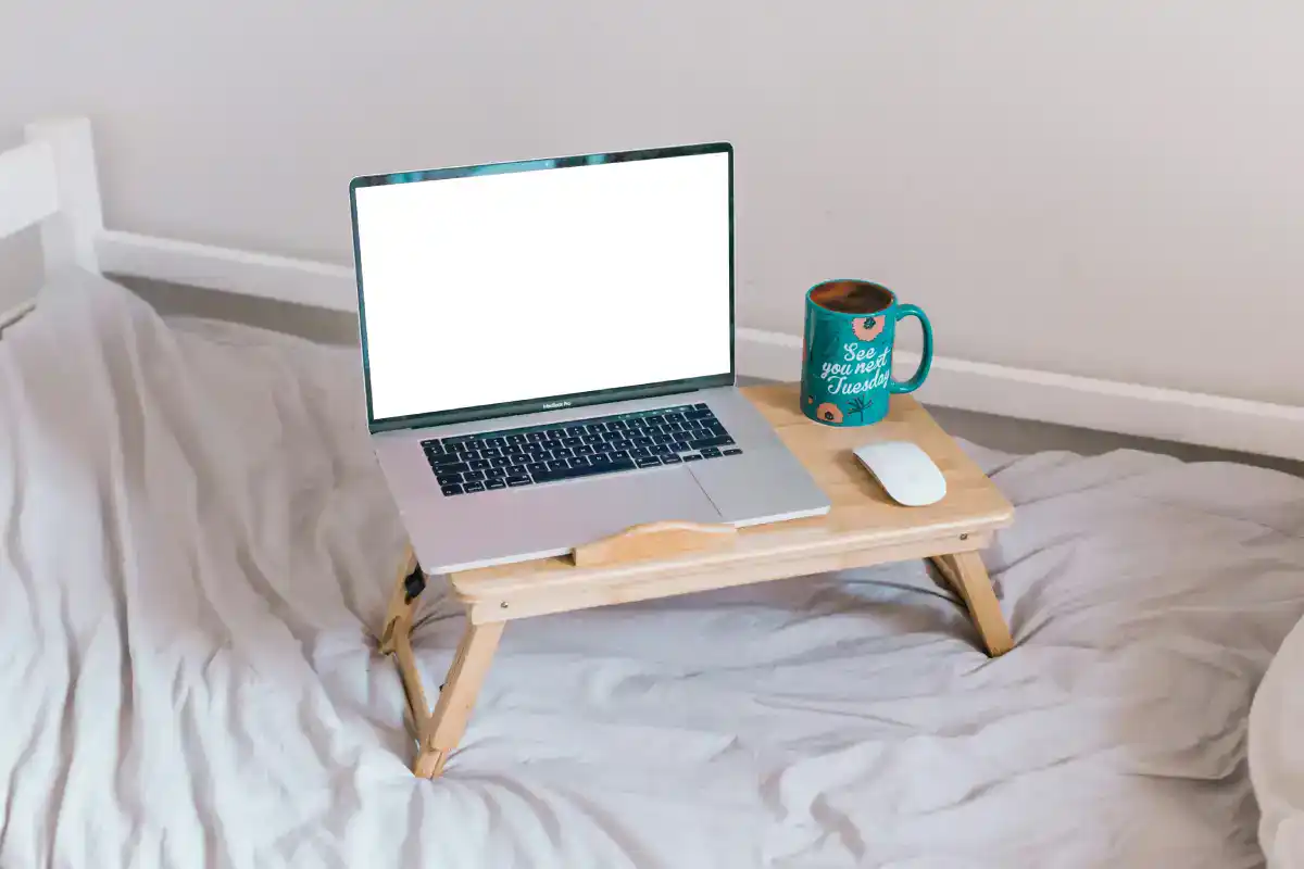 A laptop on a compact laptop table for home office setup, ideal for small spaces and remote work productivity