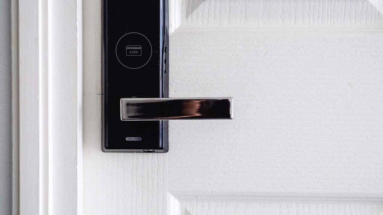 Modern smart lock installed on a front door, enhancing home security.